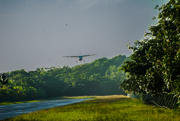 Passenger plane coming in on jungle landing strip in Torguguero.